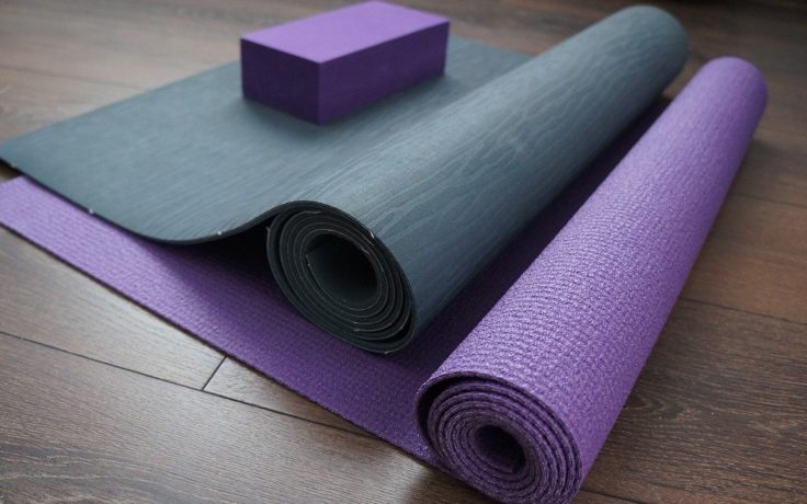 two yoga mats on a wood floor