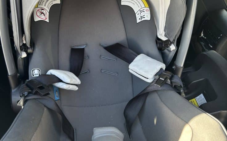 Nuna car seat front view with straps tied back