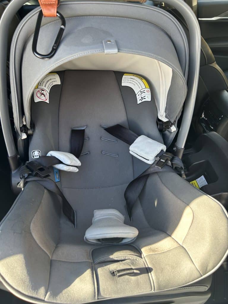 Nuna car seat front view with straps tied back
