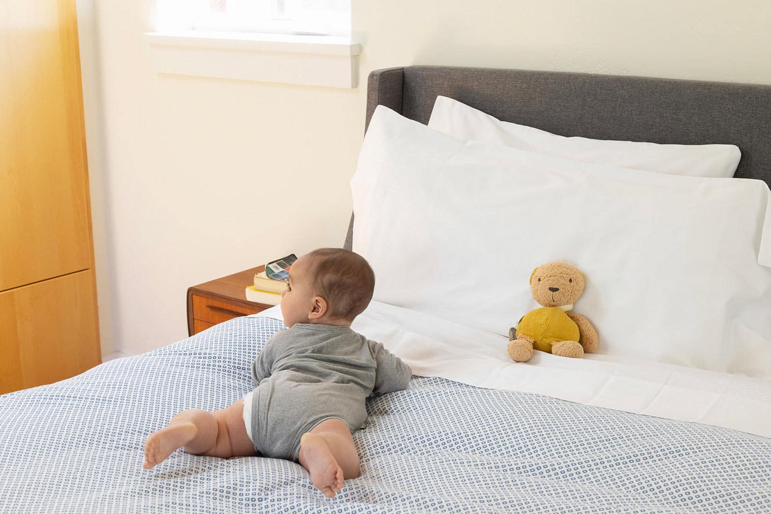 Baby laying on bed